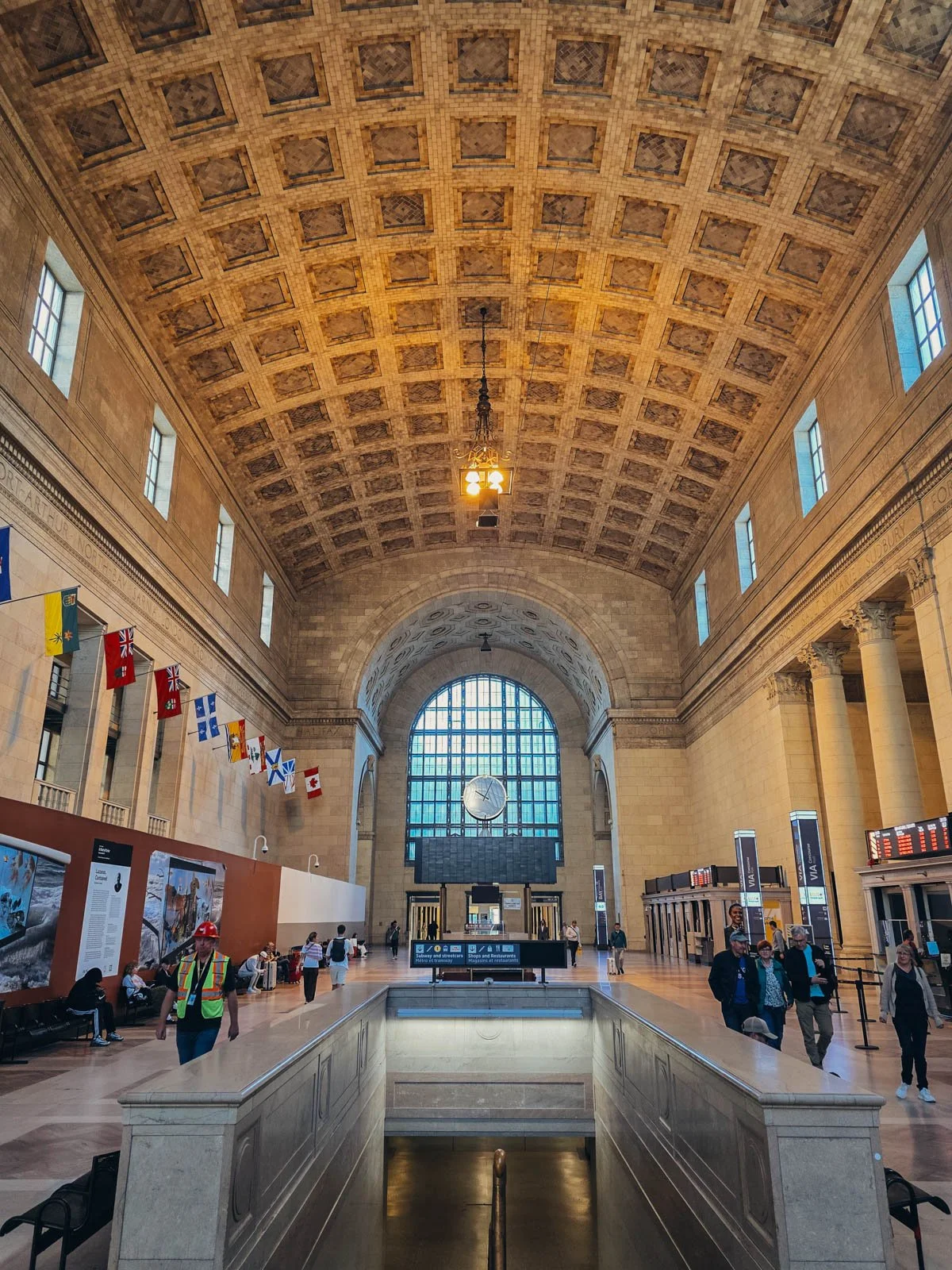 The grand stone interior of a train station with vaulted ceilings and a large window at the far end, the starting point of our Eastern Canada itinerary by train