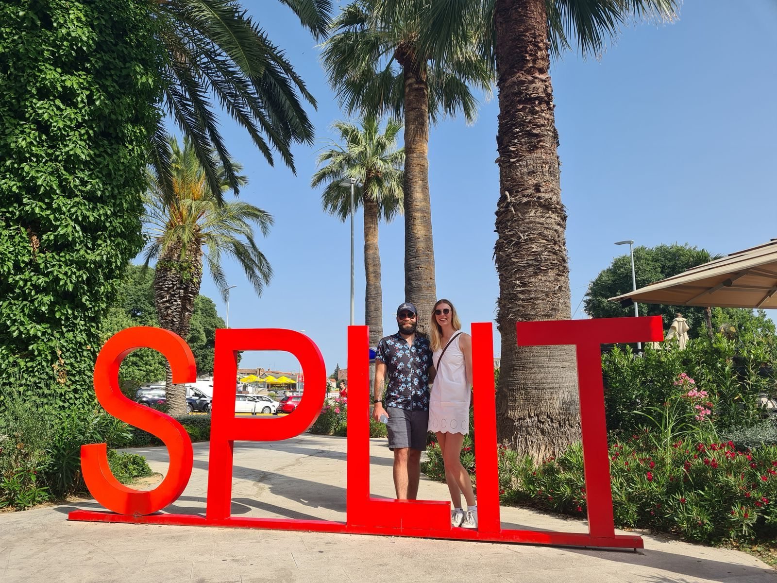 two people standing behind big red letters that read 'Split'