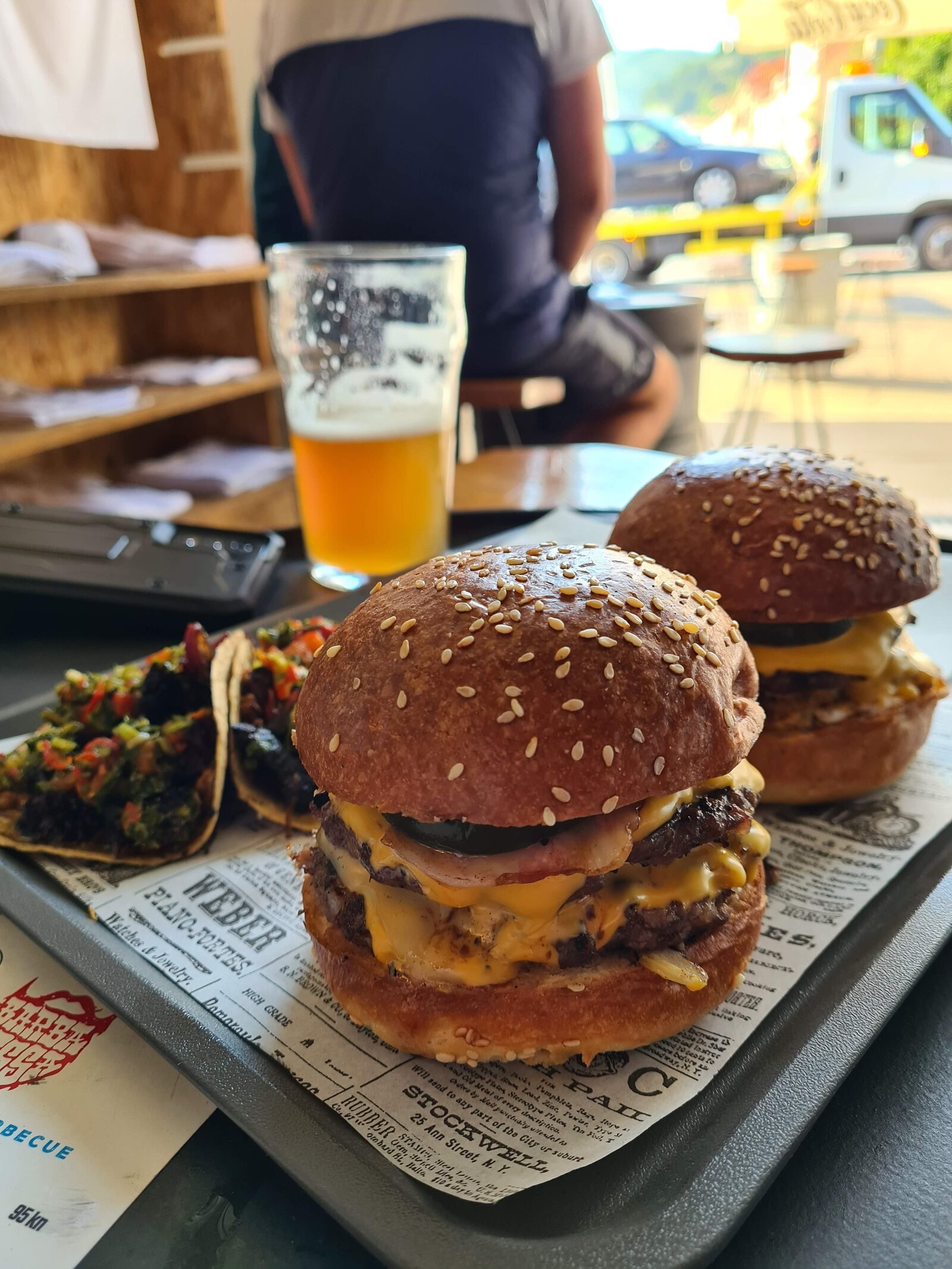 stacked burger, tacos and a beer on a table at a brewery in Dubrovnik