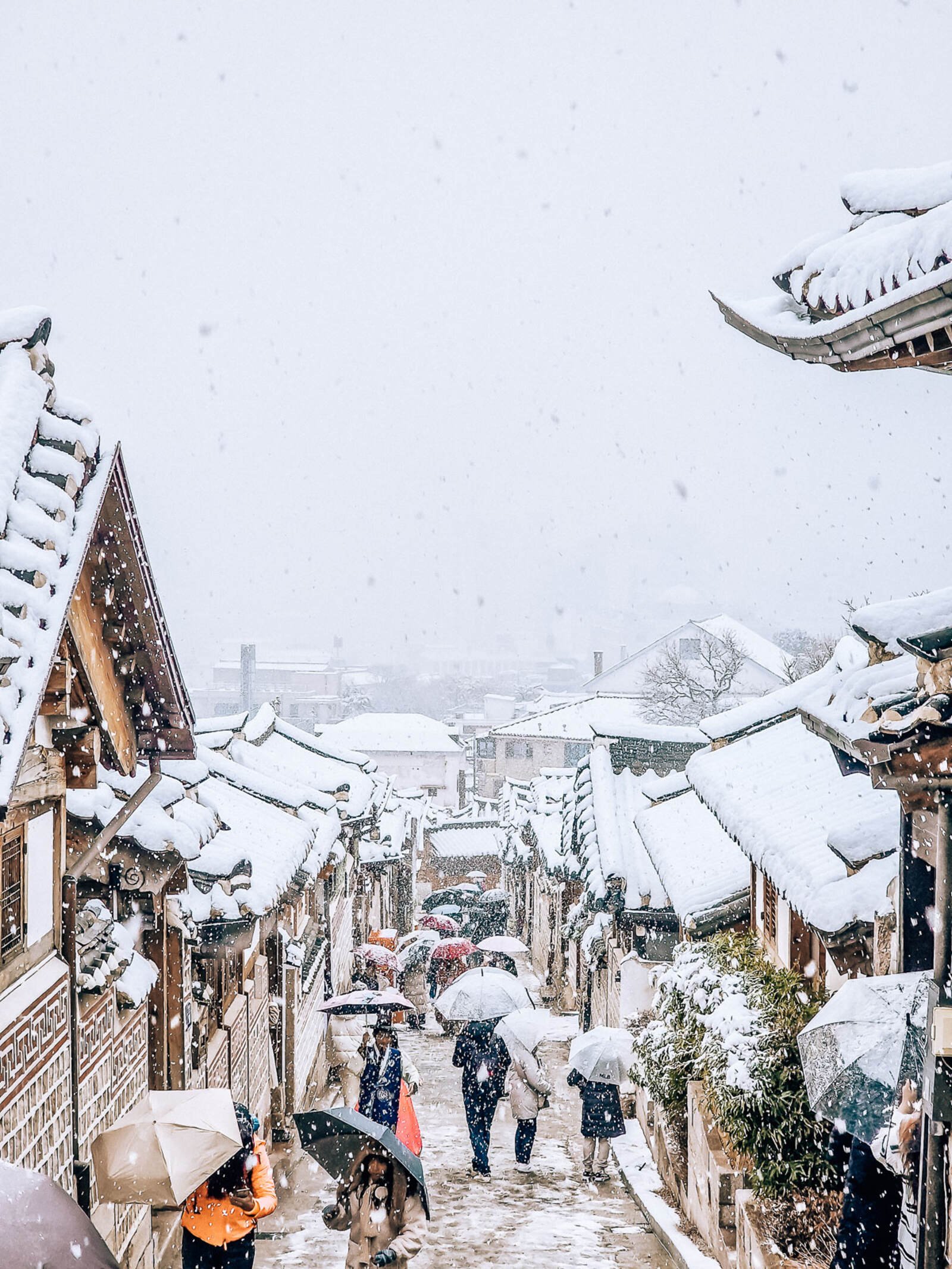 a snowy street in a traditional Korean village in Seoul, South Korea
