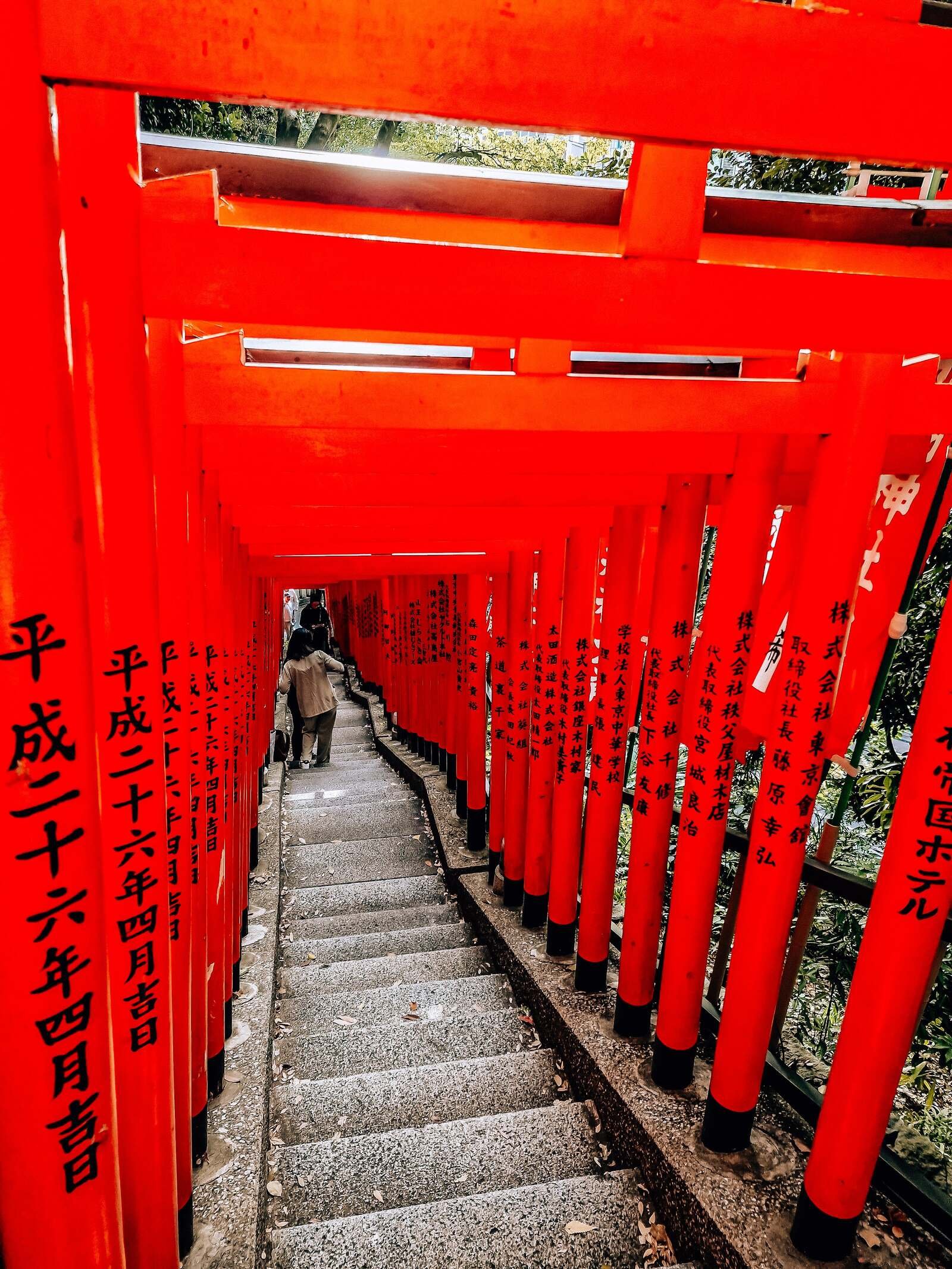 a set of steps covered by a eries of orange torii gates in tokyo