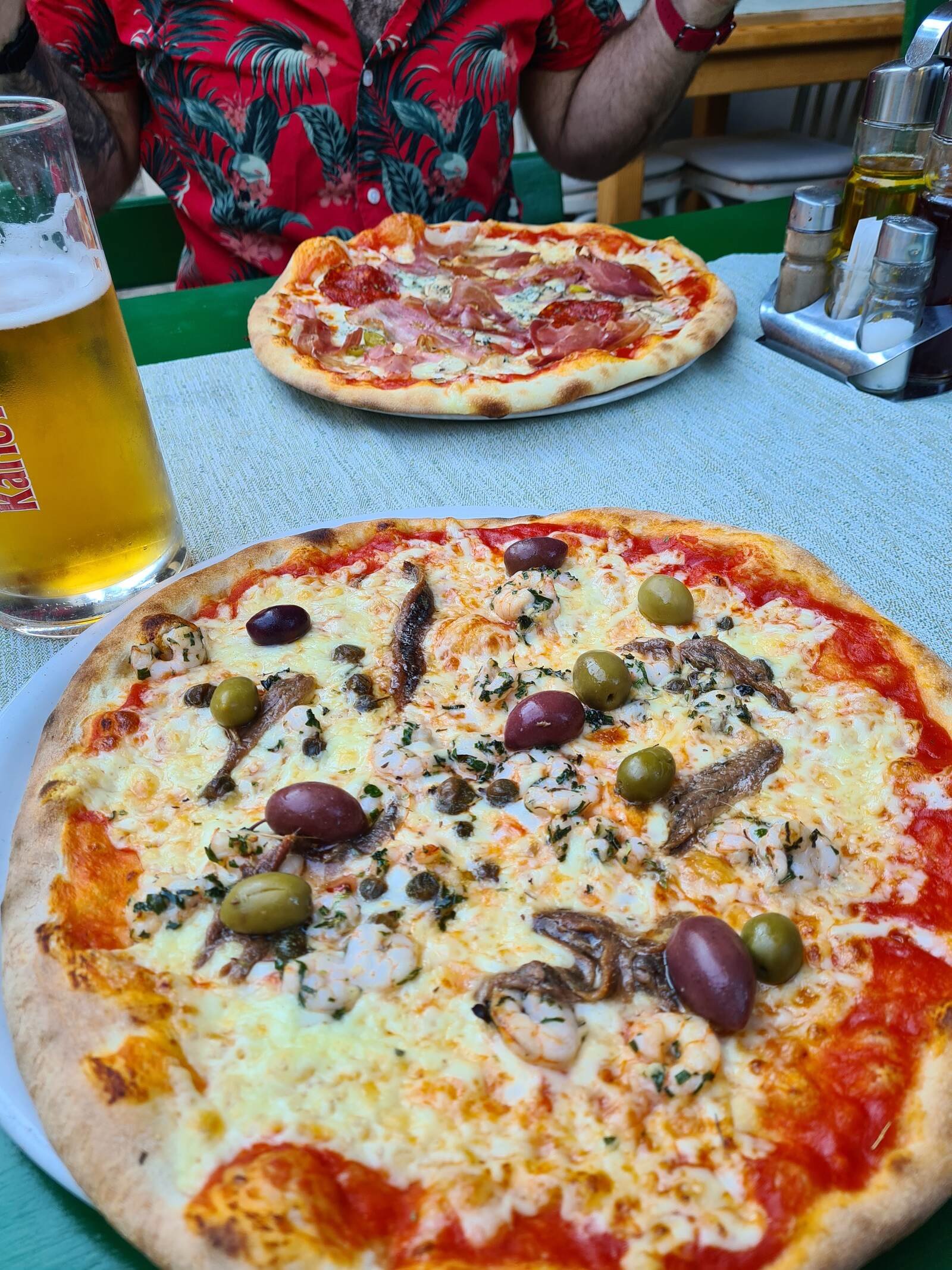 Two large hot pizzas with lots of cheese and multiple toppings