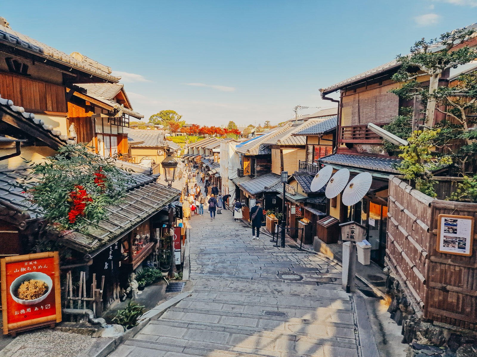 a traditional Japanese street with wooden houses and stone steps