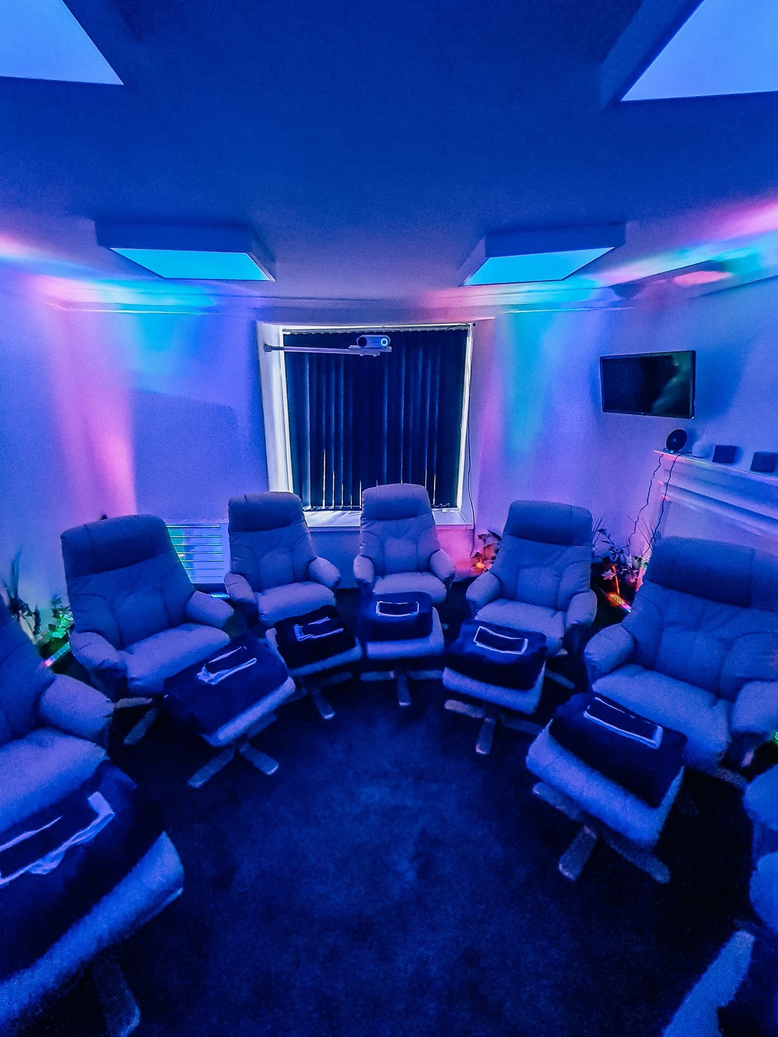 low lit blue light room with comfy chairs