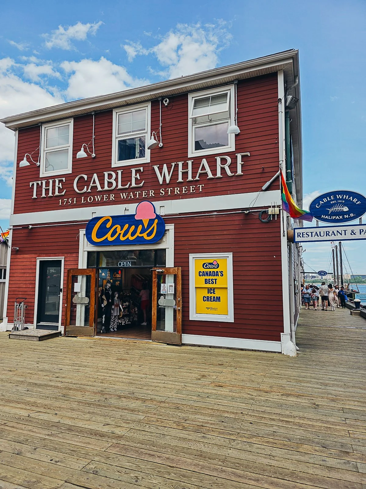 A large red and white wooden shop surrounded by wooden decking