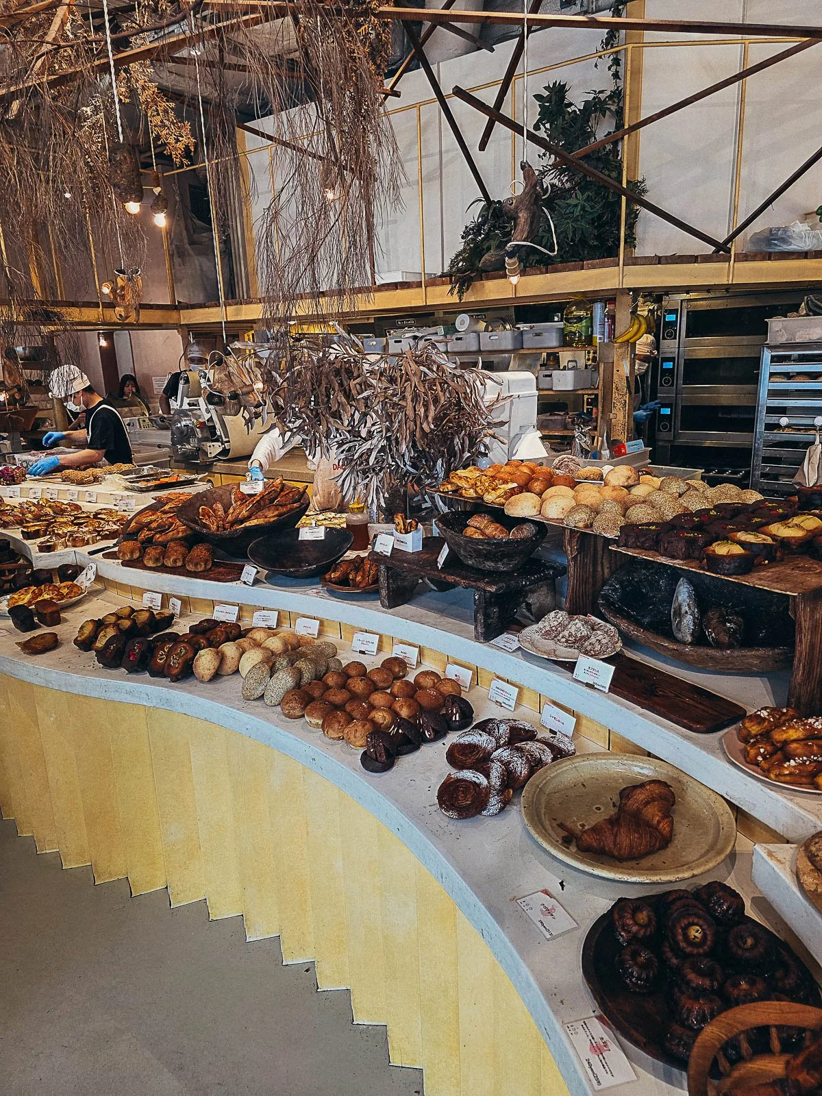 A large winding table in a bakery with many pastries on the table