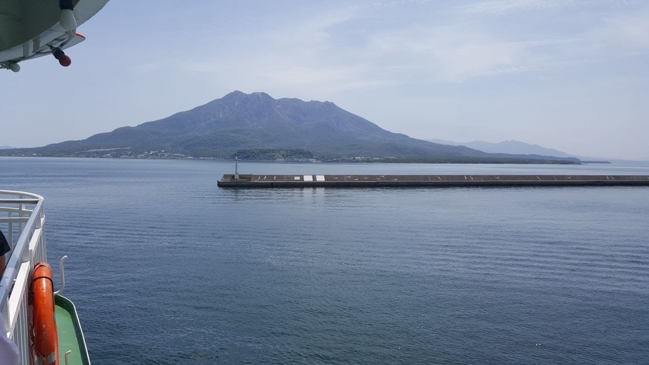 View of a volcnao island surrounded by the sea