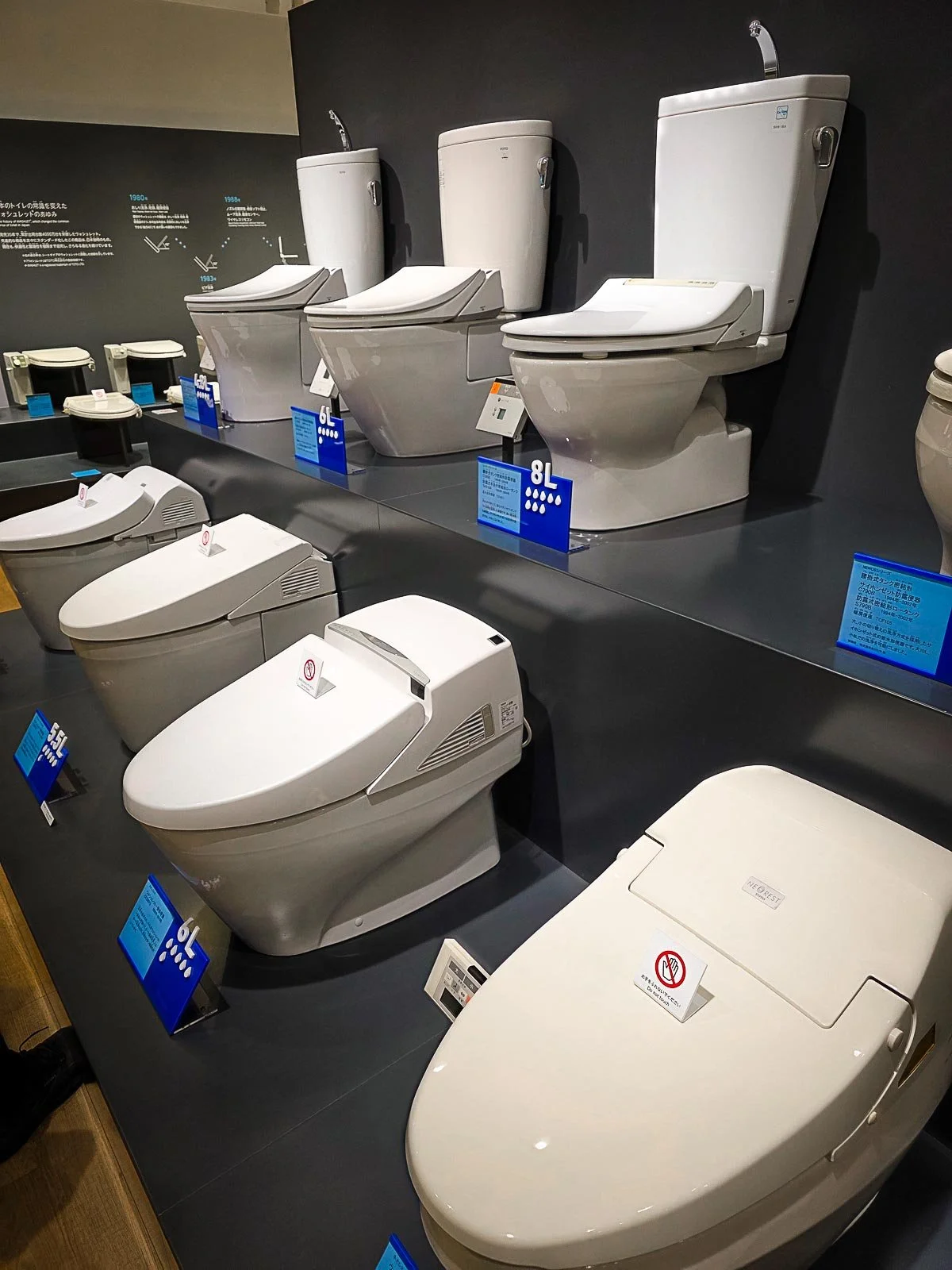 Many white toilets on display at the Toto museum