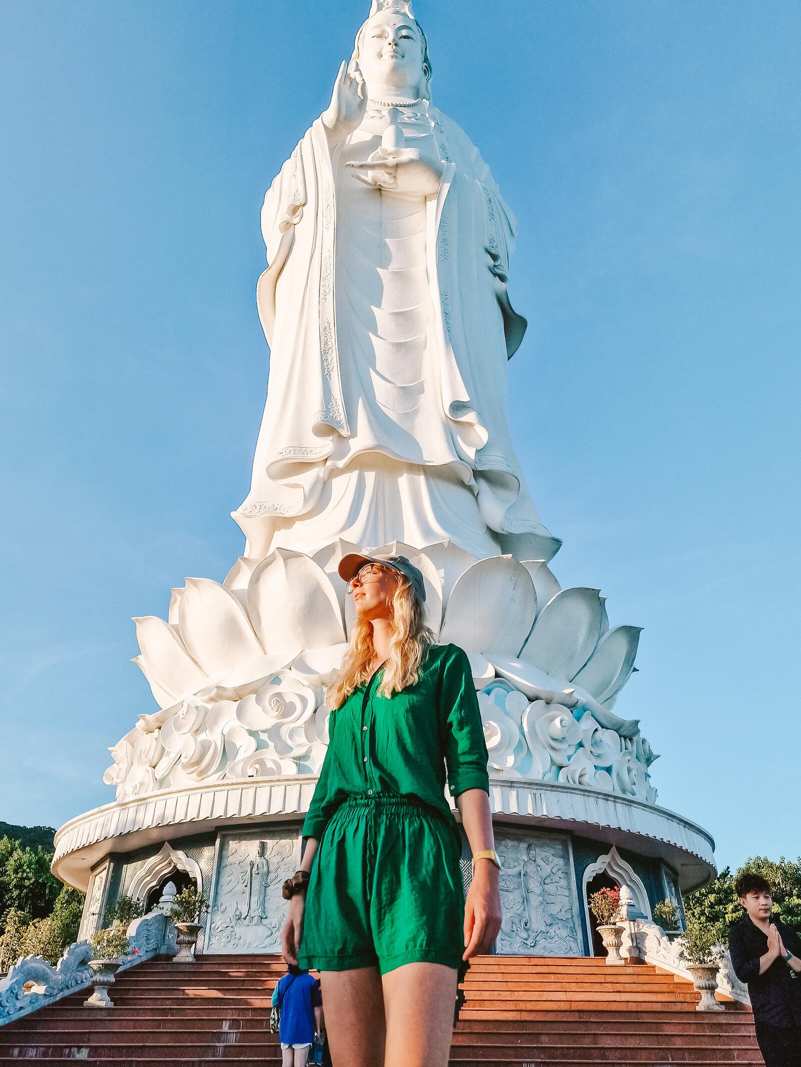 Helena standing in front of a huge white  lady buddha statue in Da Nang Vietnam