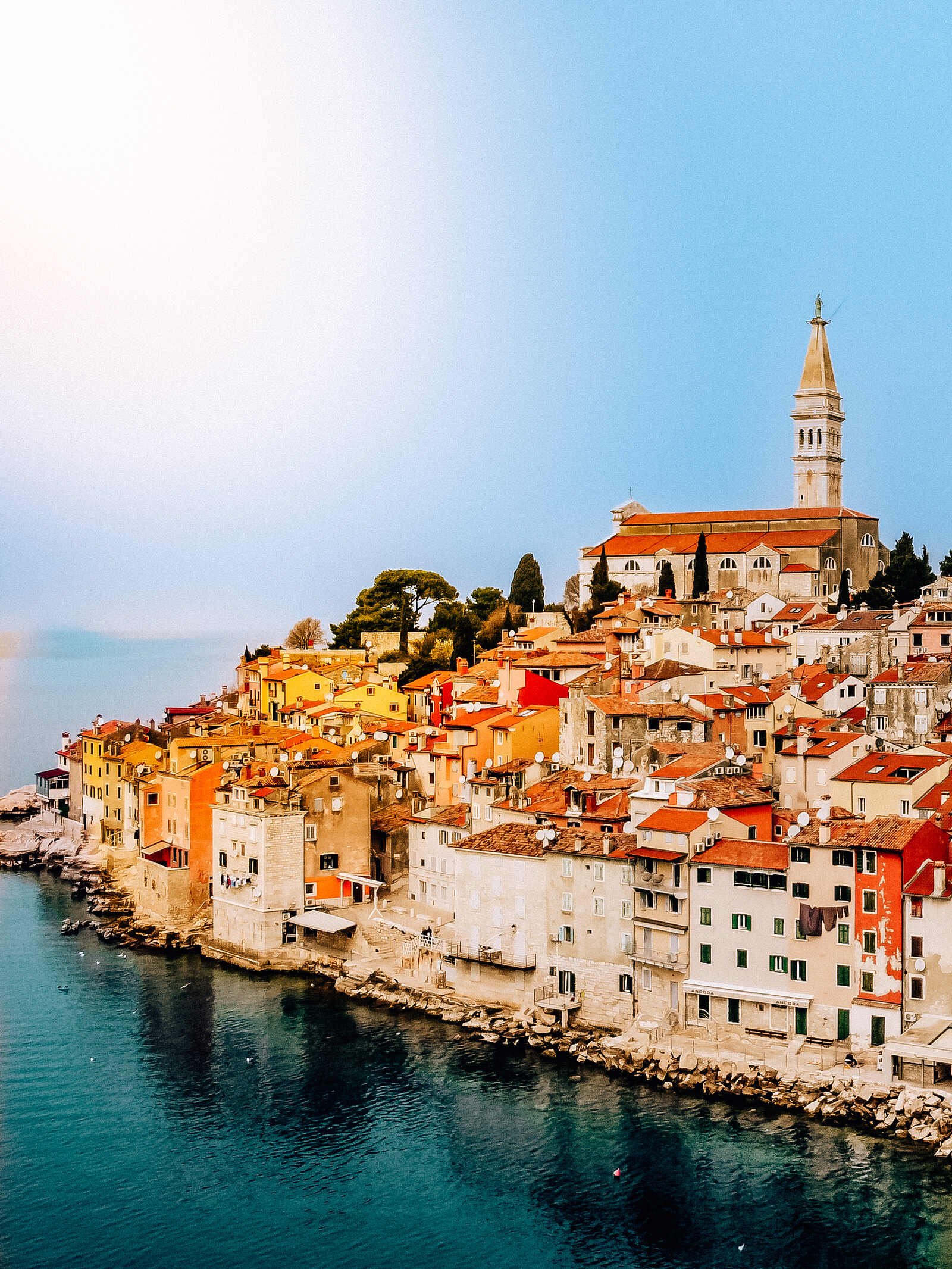 a colourful old town on a rocky peninsula surrounded by the sea in Croatia