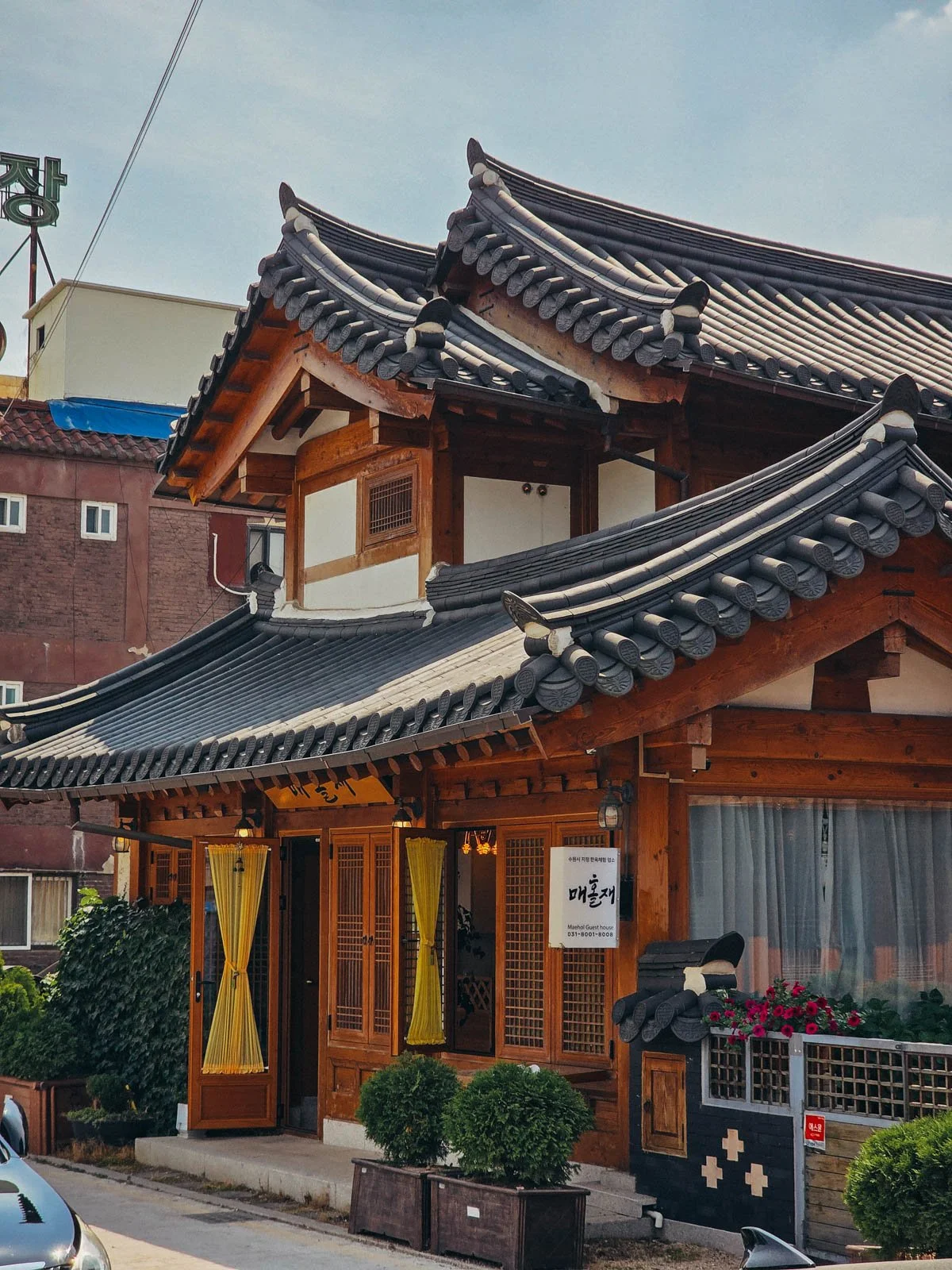 A traditional Korean building  with a wooden exterior and ornate roof