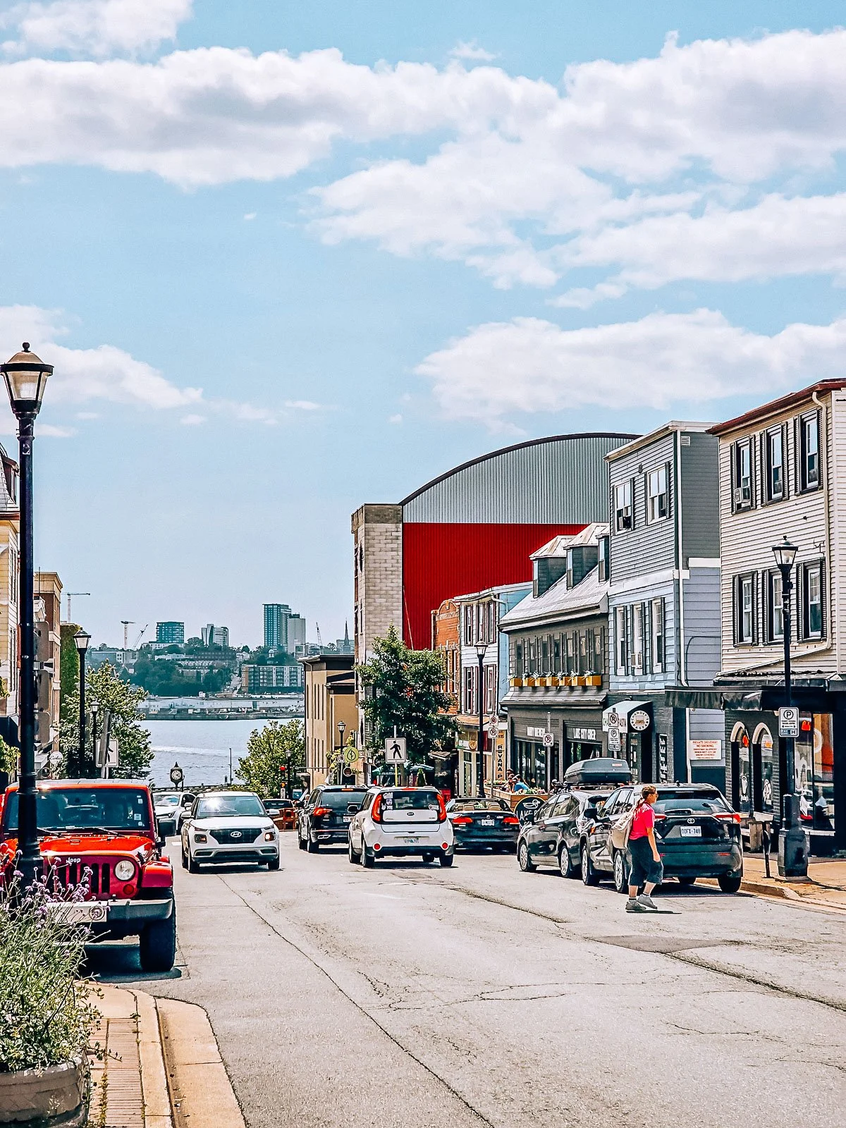 A large street with many shops and a large body of water in the distance in Dartmouth