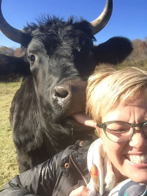 Jen getting the “wet willie” (a big wet tongue in her ear) that she talked about on the podcast.