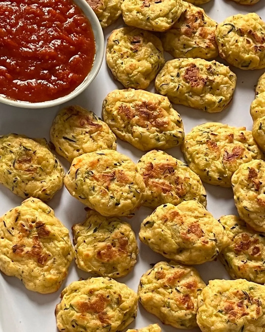 Even if nobody's coming by, there&rsquo;s something celebratory about these little bites from a recipe by Camilla V. Saulsbury from "The Chickpea Flour Cookbook. They are easy to make: a simple blend of zucchini, onion, parmesan cheese, eggs, an