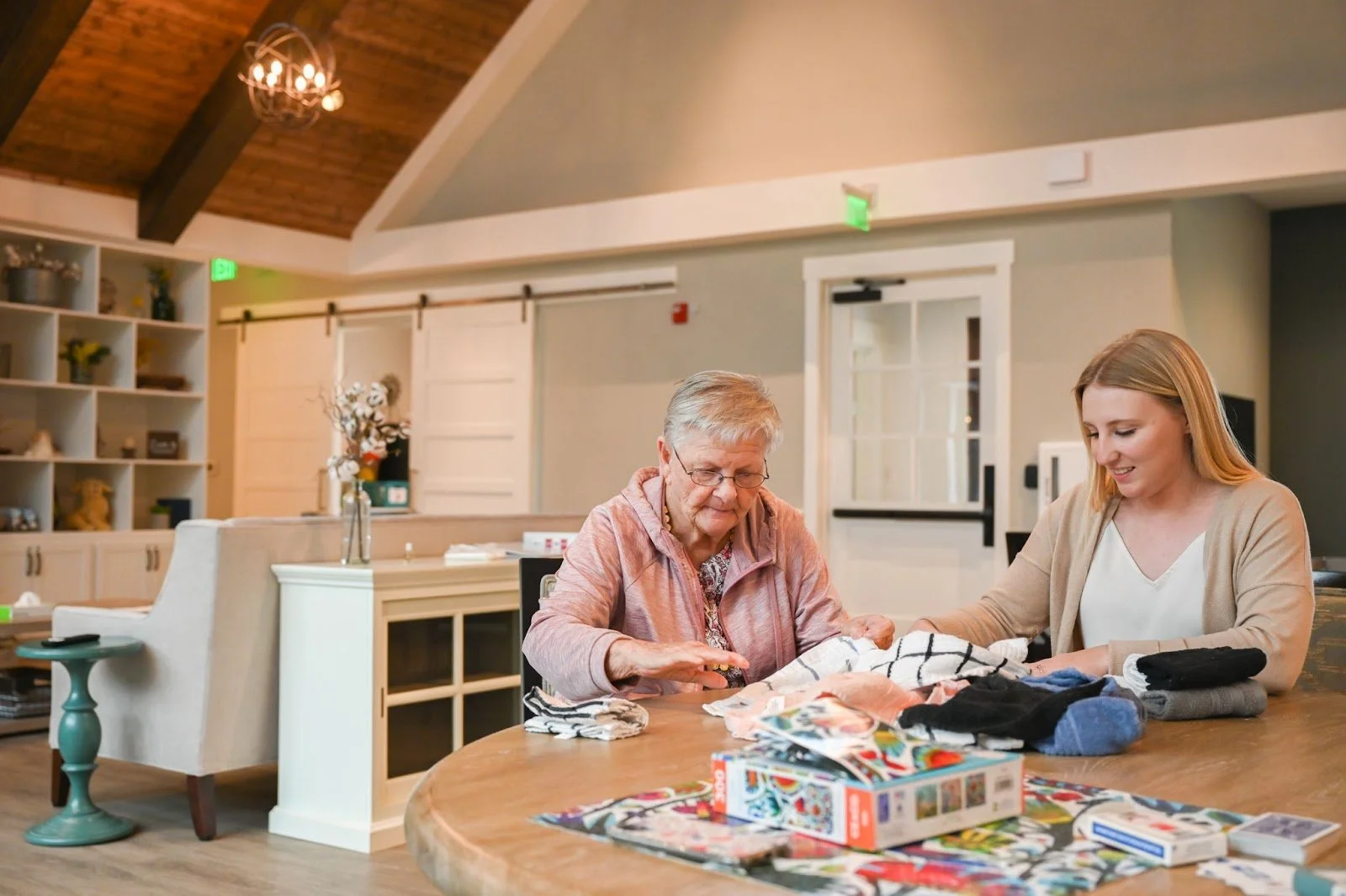 Resident folding towels with a team member
