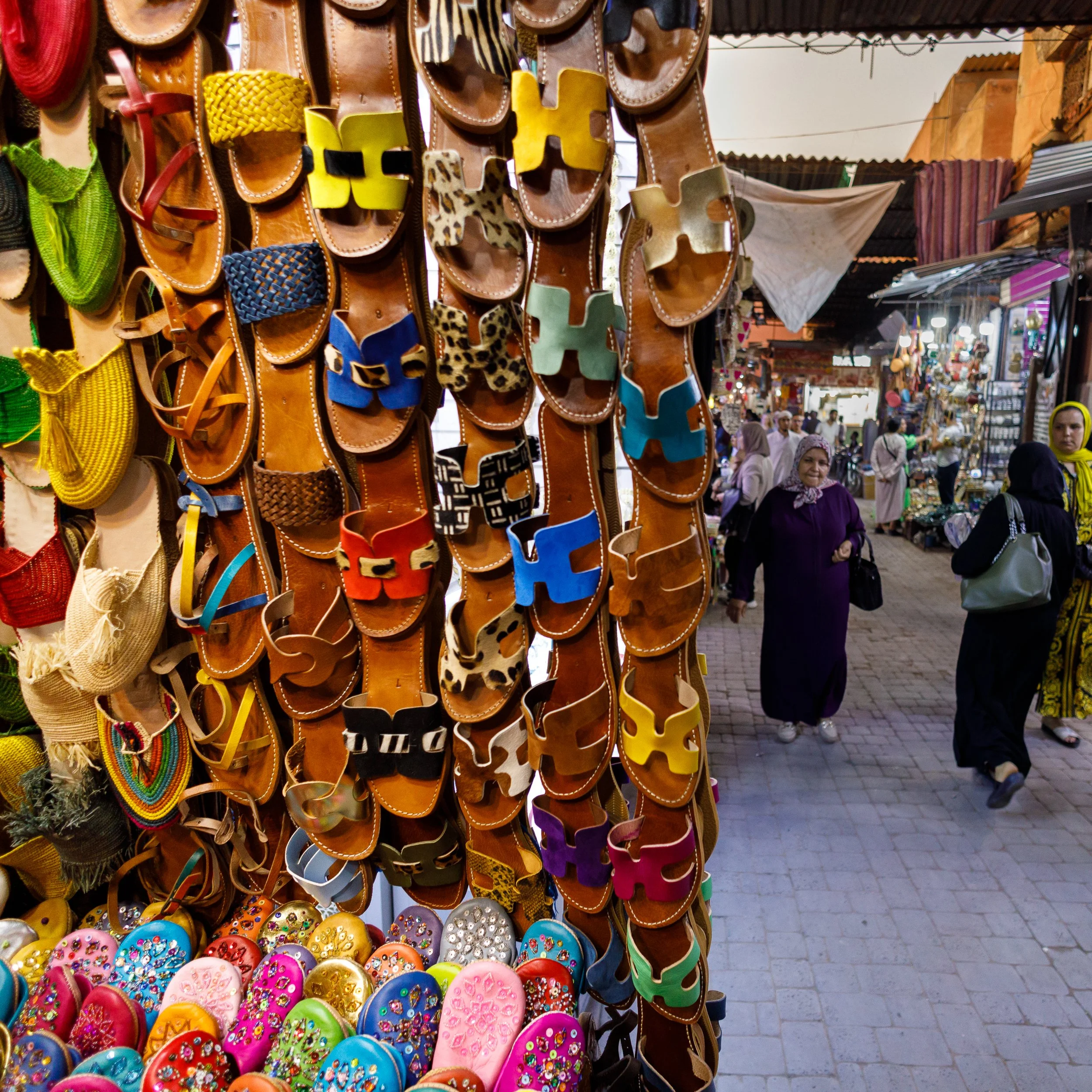 Souk market in Marrakesh with sandals for sale