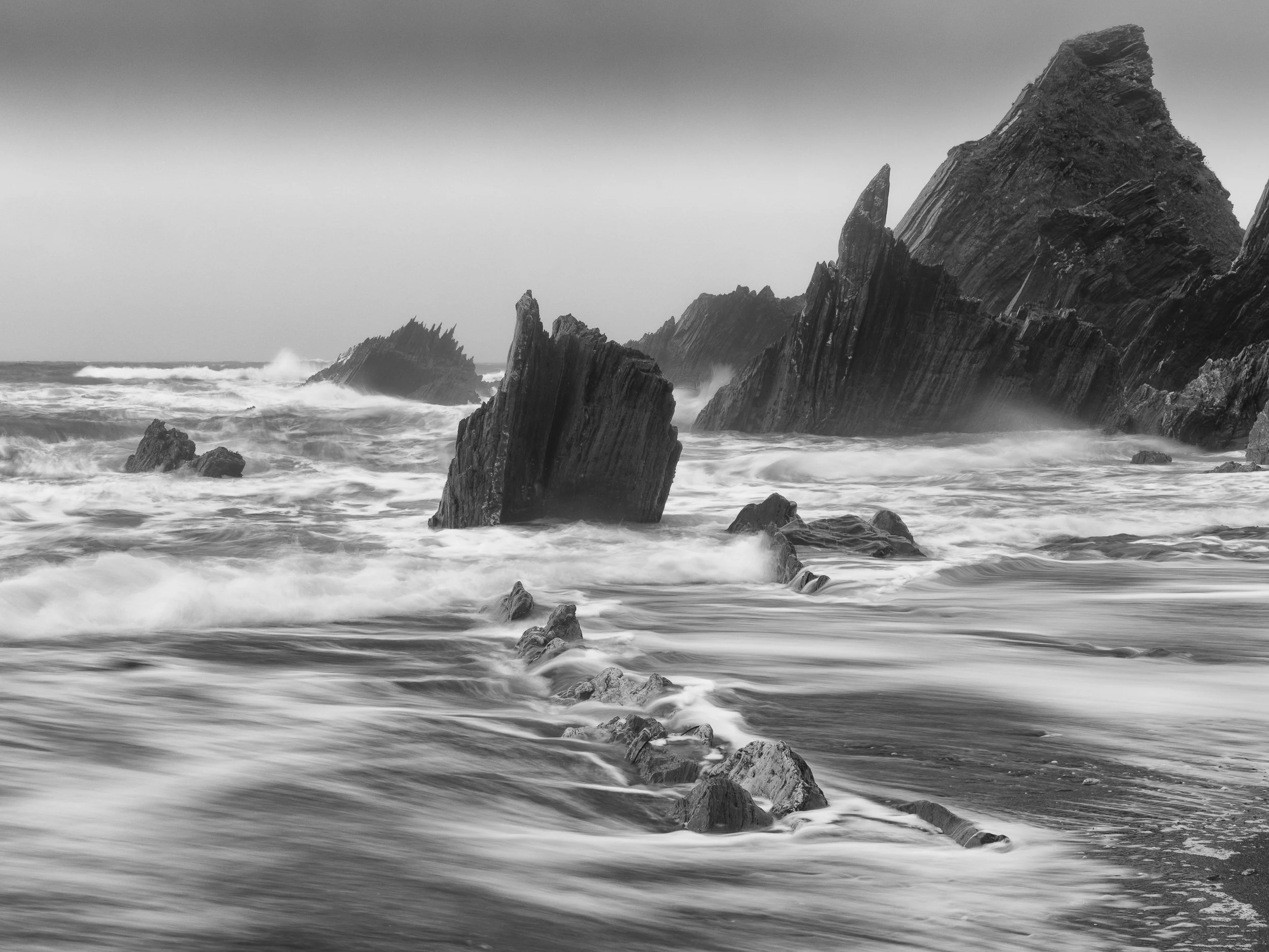 Black and white photography picture of wild sea storm and rocks as fine art wall art print
