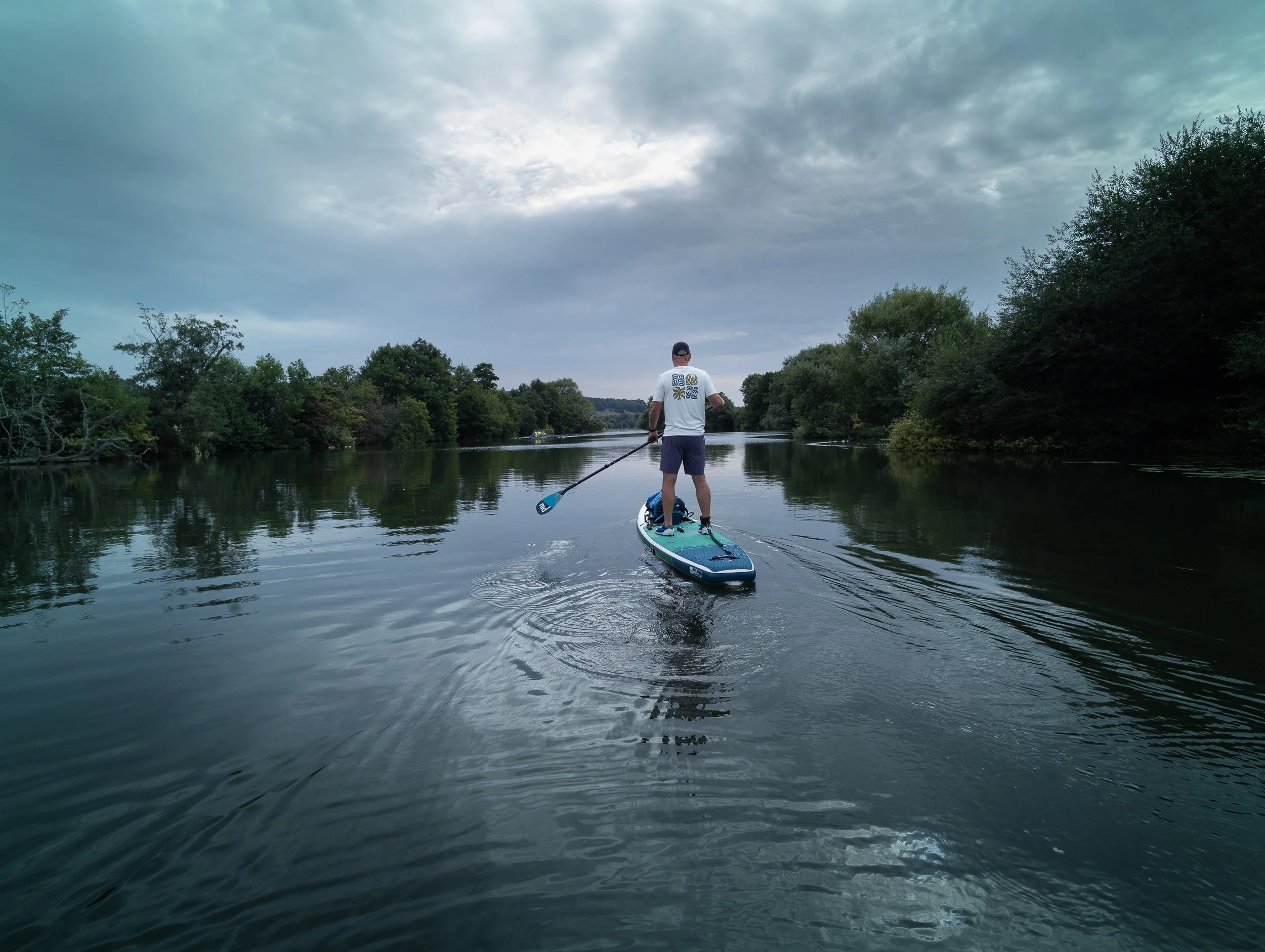 Man on a paddle board in the river Thame