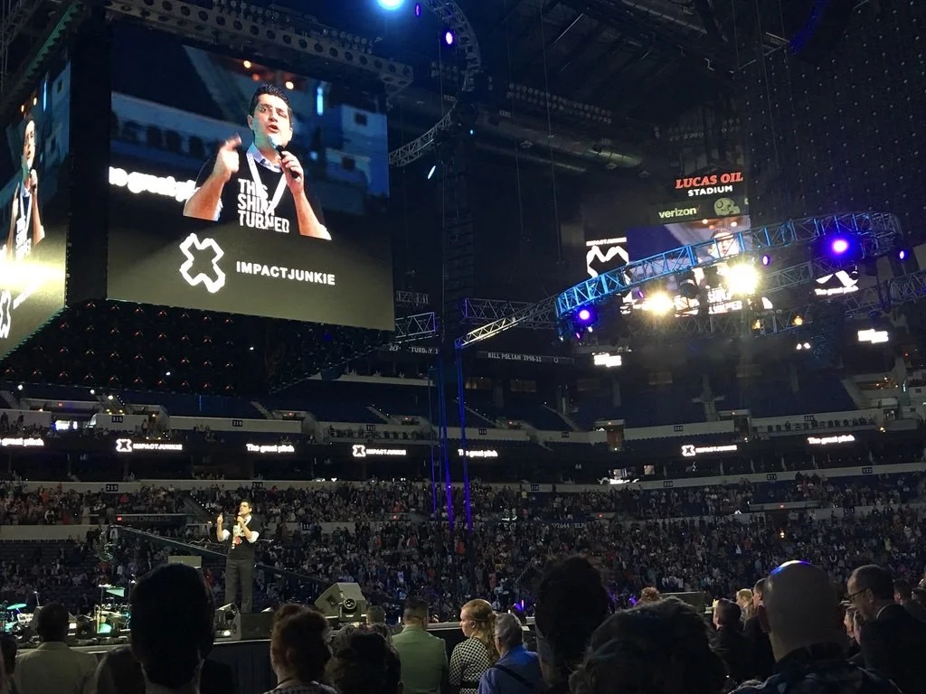 Philip Harding speaking on stage in stadium