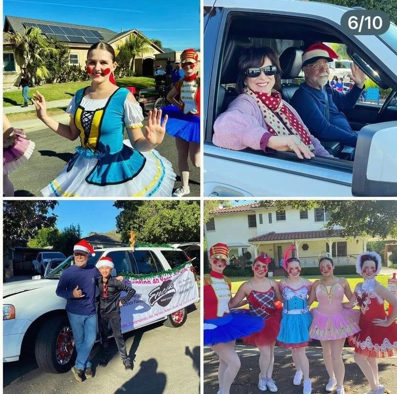 People dressed in colorful costumes and Santa hats participating in a festive parade or celebration outdoors.
