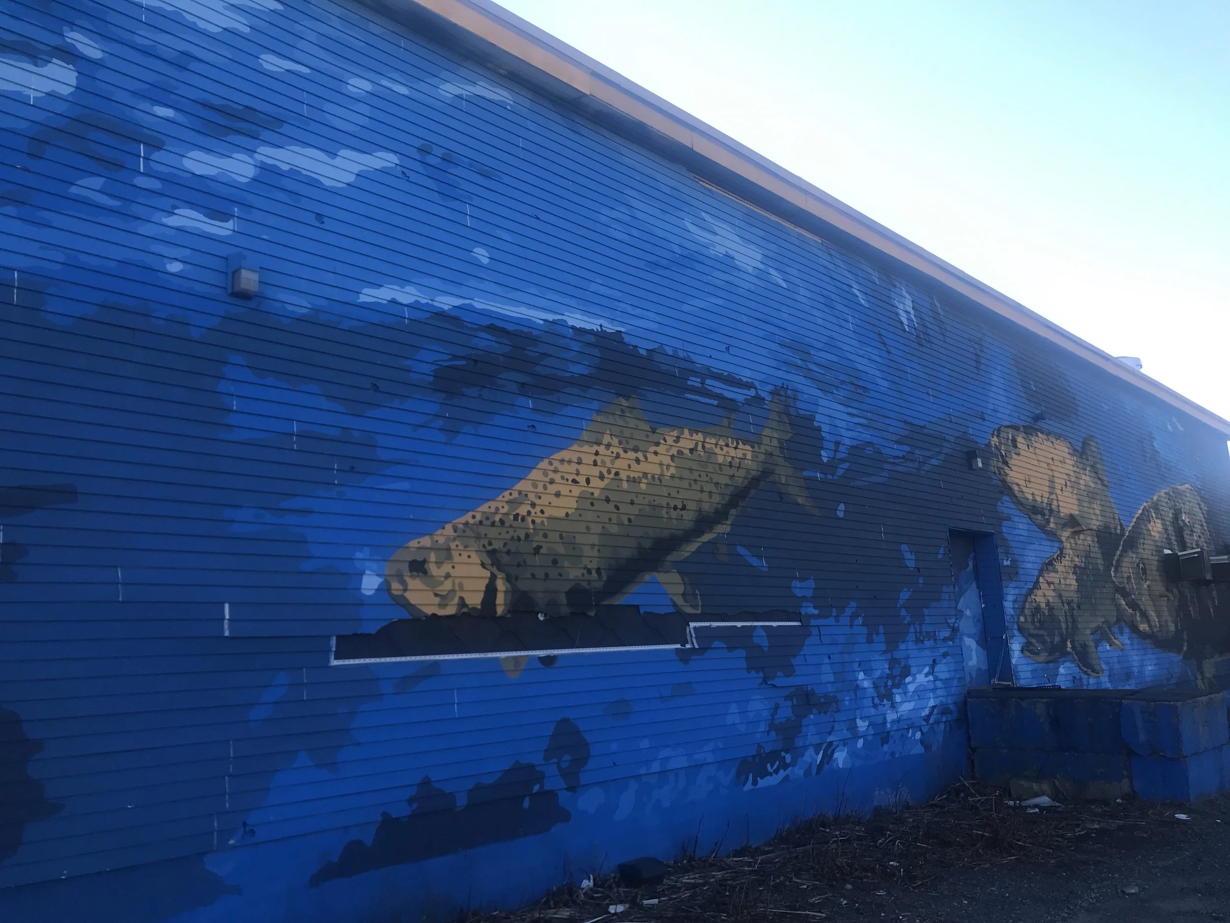 The massive Nasua River Mural overlooks the Nashua River and the Fitchburg Riverfront Park