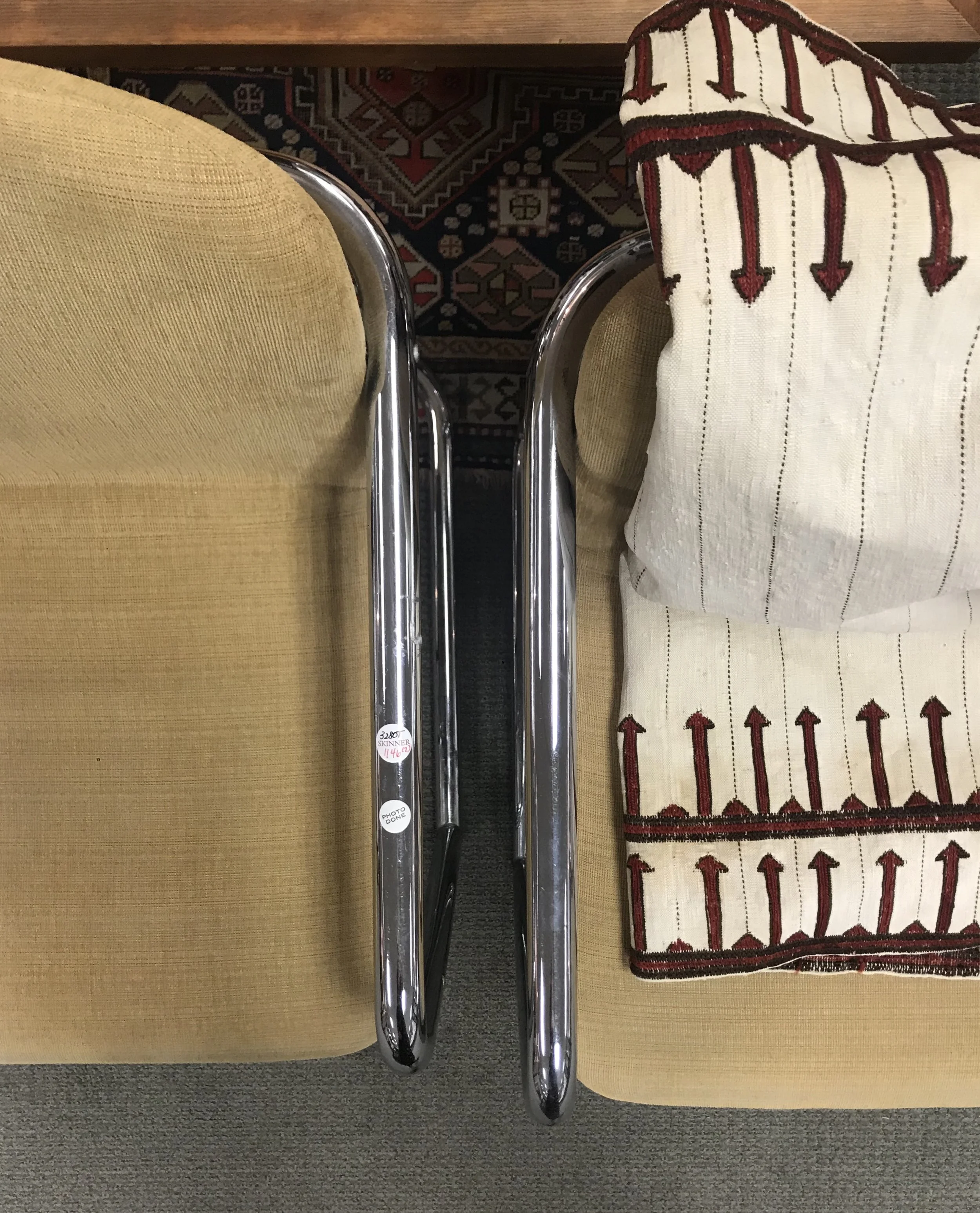 Modern Bent Steel Tube Armchairs and resting Antique Embroidered Textile from Iran.