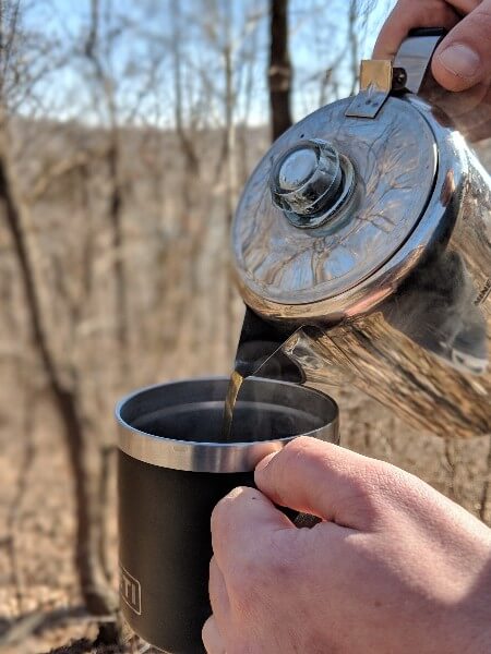 pouring cowboy camping coffee into yeti mug