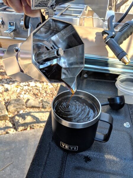 pouring bialetti espresso camp coffee into yeti mug