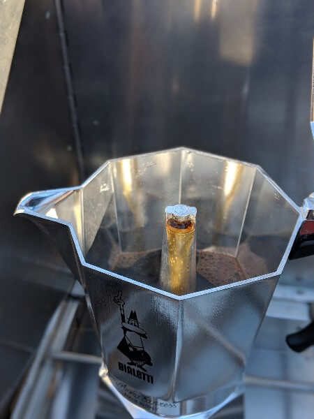 honey colored coffee in upper chamber of bialetti moka express espresso camping coffee