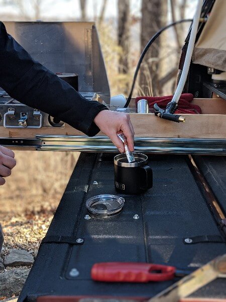 pouring starbucks instant camping coffee into yeti mug