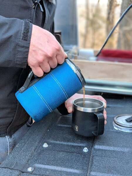 pouring camping coffee from gsi javapress into yeti mug