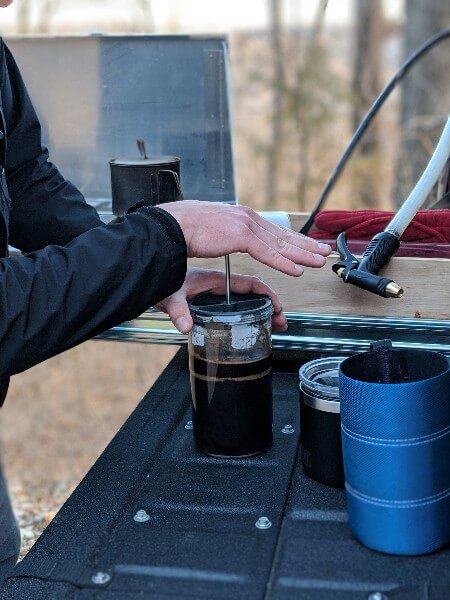 french press camping coffee plunger removing grounds from coffee