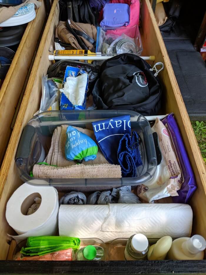 Second drawer divided up using tension rods, small rubbermaids, and other organizers