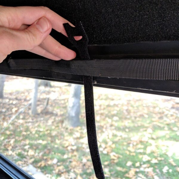 Bundling straps go behind the adhesive velcro. Position them so that only the tab is sticking up - this makes them easy to use when rolling the curtains up. 