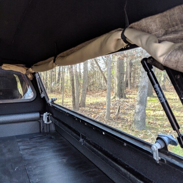 Use 3-4 bundling straps per truck camper window, two of them several inches in from each end and the others evenly spaced between.