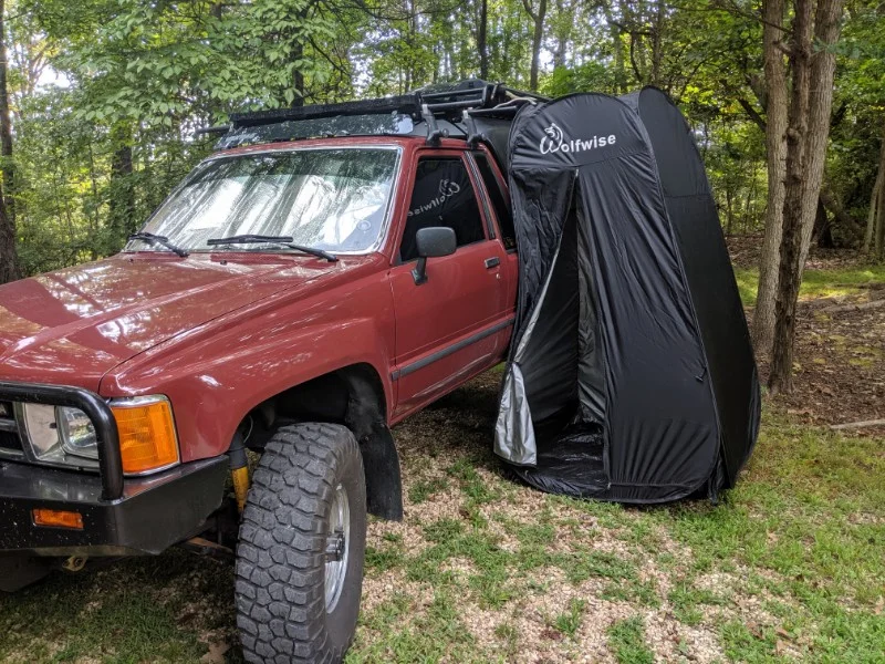 Wolfwise shower tent and road shower in use while truck camping