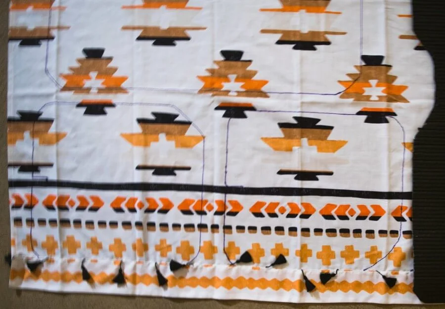 Keep fabric with a pattern level when cutting to create DIY camper curtains or window covers.