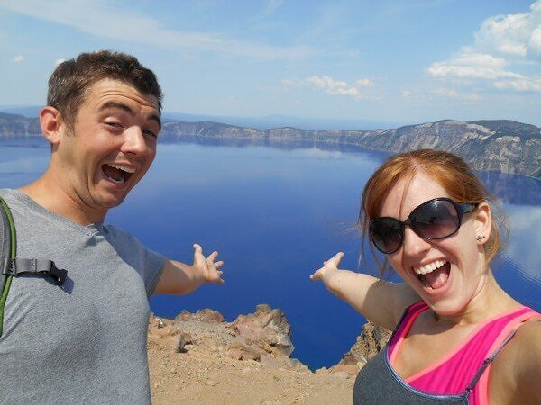 man and woman celebrating a hike to the viewpoint of crater lake national park