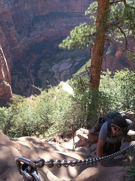 man climbing angel's landing trail in zion national park