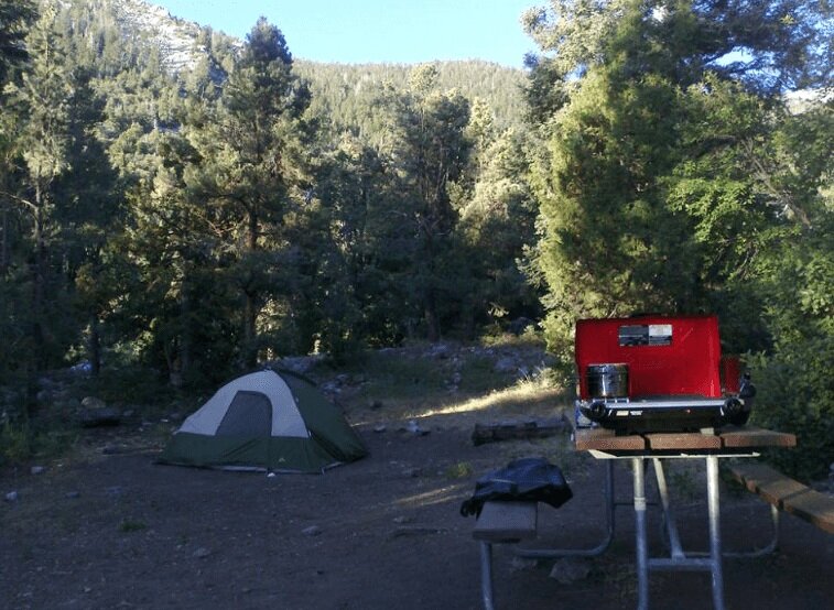 green tent set up near camp stove at great basin national park