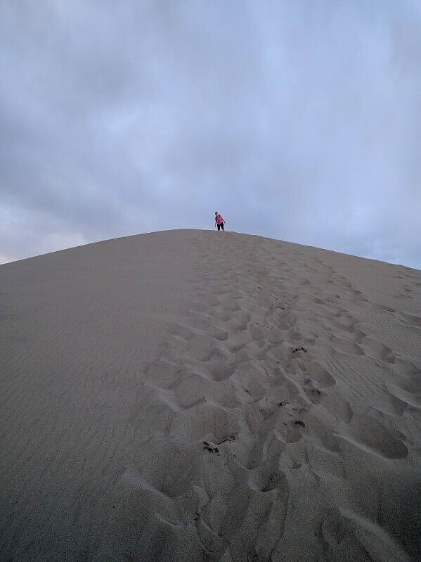 girl at top of sand dunes in national park