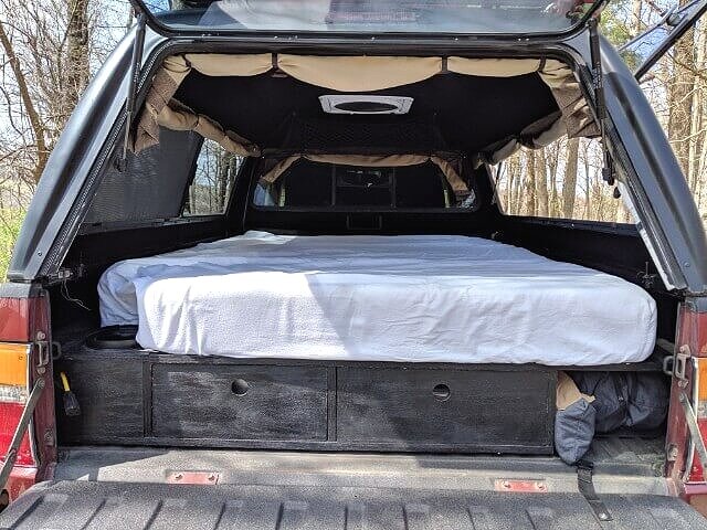 memory foam camping mattress on a truck bed sleeping platform