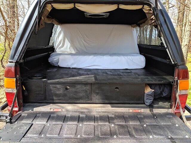 folding truck bed mattress in couch mode for lounging in the back of a pickup or suv