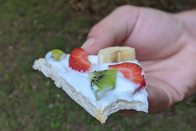 Camping breakfast pizza with fruit and yogurt as a camping meal for kids.