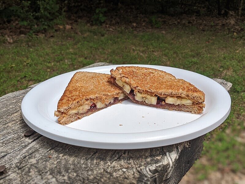 Grilled peanut butter and jelly sandwich as an easy kid-friendly camping food.