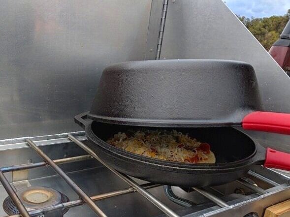 Dutch oven camping pizza as a camping meal for kids.