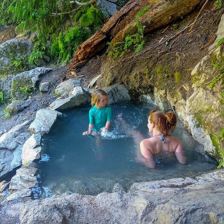 family visiting upper pool of weir creek hot springs in idaho