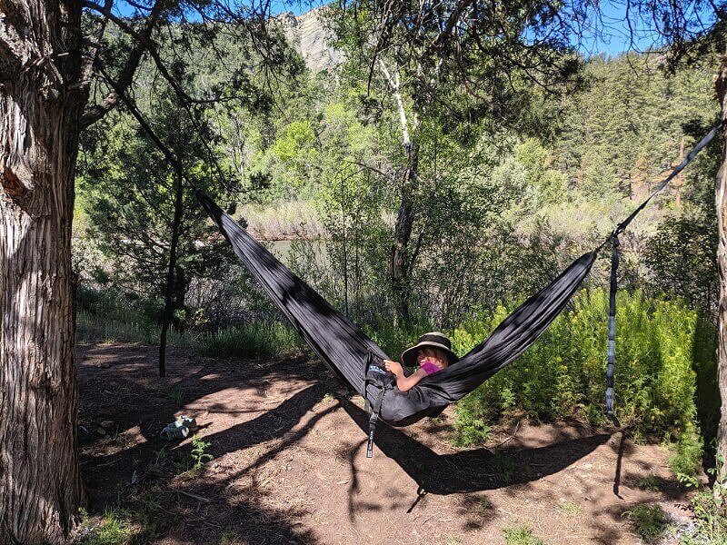 relaxing in a hammock while truck camping