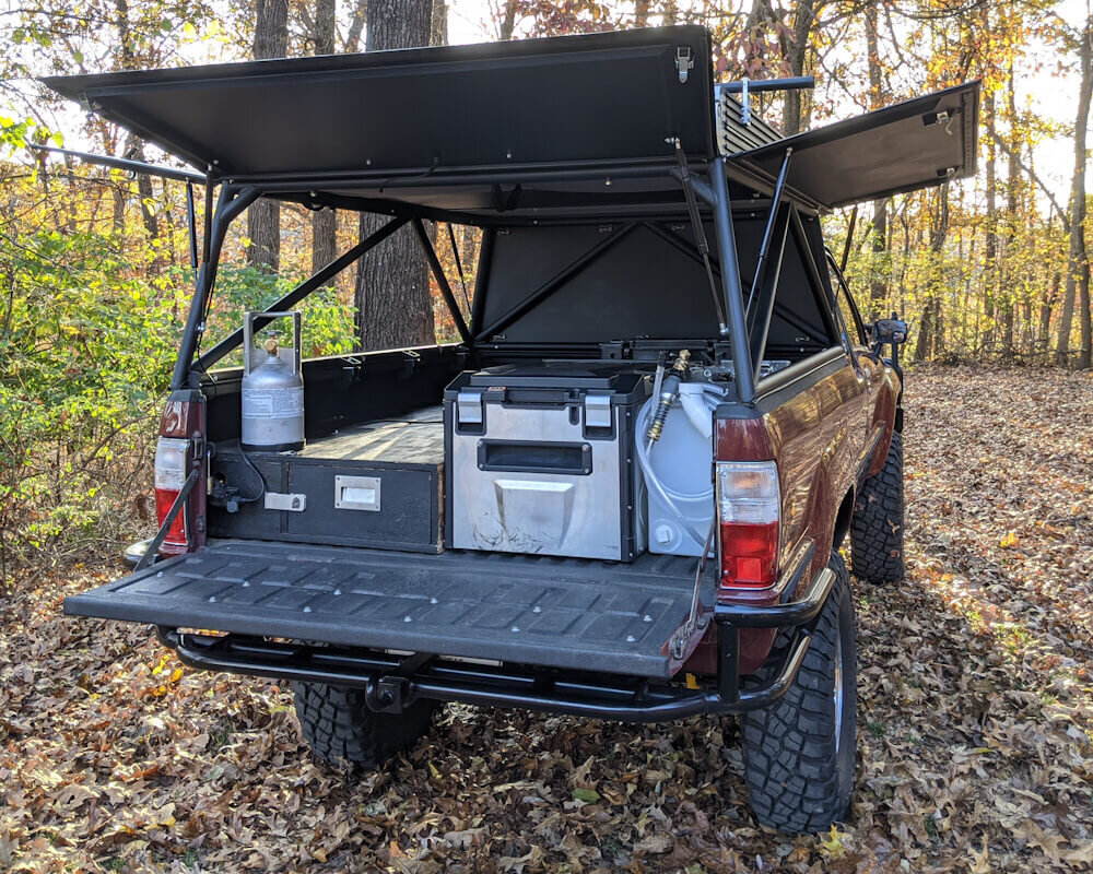 Finished homemade DIY truck camper build with all fixtures installed for overlanding travel