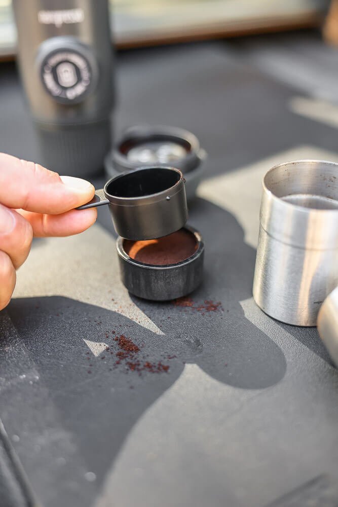 tamping the grounds using the camping espresso maker scoop